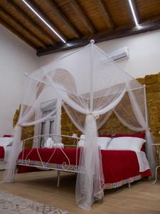 a bedroom with two beds with a mosquito net at Anima Templi in Agrigento