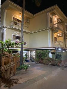 a large house with a fence and a staircase at Calangute Beach Prime in Calangute