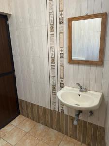 a bathroom with a sink and a mirror at Calangute Beach Prime in Calangute