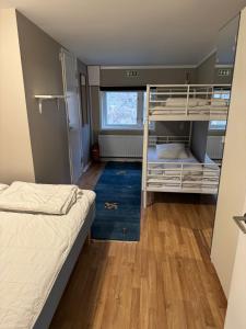 a bedroom with two bunk beds and a window at Hällestrand nr 6 Seaview in Strömstad