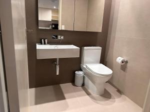 a bathroom with a white toilet and a sink at Collins Serviced Apartments in Melbourne +15 photos