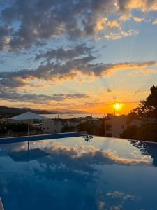 a view of the sunset from a swimming pool at Panorama Hill Hotel in Iraklitsa