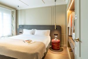 a hotel room with a bed with a book on it at El Avenida Palace in Barcelona