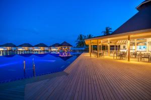 a resort with a swimming pool at night at Ellaidhoo Maldives by Cinnamon in Hangnaameedhoo