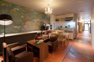a living room with a kitchen and a dining room at Iwatoyama Hostel in Kyoto