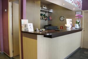 a bar in a hotel with a clock on the wall at Hostal 4C Cuatro Caminos in Madrid