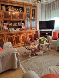 a living room with a coffee table and a television at Casa da Rapadoira in Laxoso de Abaixo