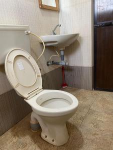 a bathroom with a toilet and a sink at Calangute Beach Prime in Calangute