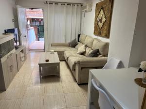 a living room with a couch and a table at Planta baja en Magic World in Oropesa del Mar