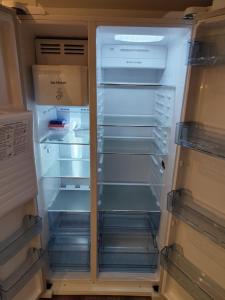an empty refrigerator with its door open with its doorsktop at Ferienhaus Liewer 