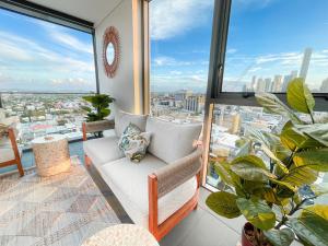 a living room with a couch and a large window at Apartments on Connor in Brisbane