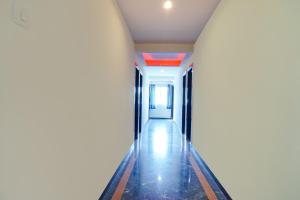 an empty corridor in a building with a hallway at FabHotel Gokul Lodge in Pune
