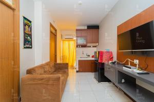 uma sala de estar com um sofá e uma cozinha em RedLiving Apartement Cinere Resort By YK rooms Tower Kintamani em Gandul