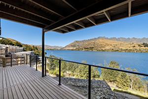 a view of a lake from the balcony of a house at Luxury Lakeside Retreat in Queenstown