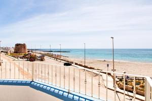 a view of a beach and the ocean at Casa Tridente - Meravigliosa villa sul mare in Torre Mozza