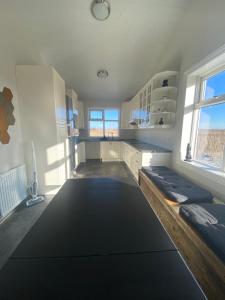 a room with a large room with a large rug at Skalarimi - Country House in Selfoss