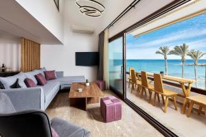 a living room with a couch and a view of the ocean at Cosmopolitan luxury apartment by Smaris Collection in Hersonissos