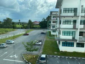 an aerial view of a parking lot next to a building at The Time in Kota Samarahan