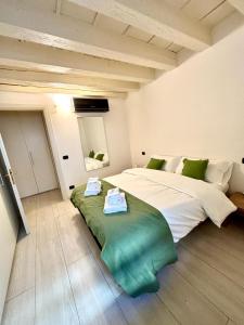 a bedroom with a large bed with two towels on it at SanPietro in Verona