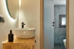 a bathroom with a sink and a shower at Cosmopolitan luxury apartment by Smaris Collection in Hersonissos +17 photos