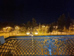 a fence with lights in a park at night at Sahil city view in Baku