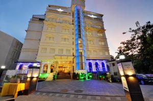 a large building with blue lights on it at Hotel Ramanashree Richmond in Bangalore