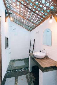 a bathroom with a sink and a wooden counter at Himaya in General Luna