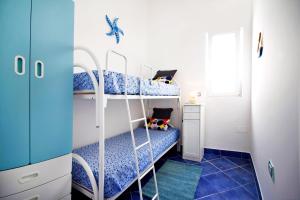 Ένα ή περισσότερα κρεβάτια σε δωμάτιο στο Casa di Giò - Confortevole casa sul mare