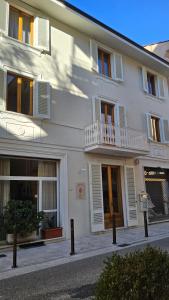 a white building with white windows and a balcony at Verena Dependance Savoia & Campana in Montecatini Terme