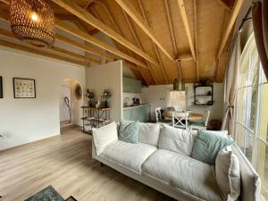 a living room with a white couch and a table at Royal Veluwe in Putten