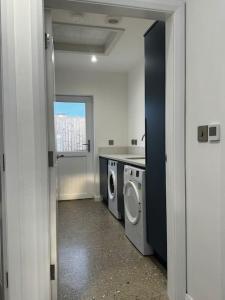 una lavanderia con lavatrice e asciugatrice di Prospect View Unit A a Portstewart