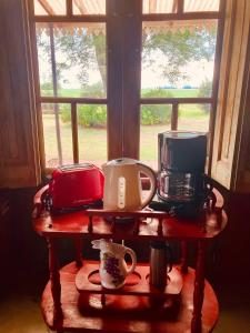 a table with pots and pans on it in front of a window at La Madreselva in San Antonio de Areco +9 photos