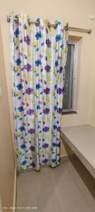 a shower curtain in a room with a window at Hotel JM International (A Unit of Hotel Care Plaza) in Puri