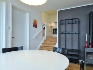 a white dining room with a white table and chairs at Lommedalen Panorama 55m2 in Bærums Verk