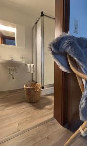 a bathroom with a shower and a sink and a mirror at Pension Stöllinger mit Traumausblick in Fuschl am See