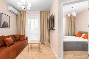 Wiktoryn 6 by Homeprime في وارسو: غرفة معيشة مع أريكة وسرير
