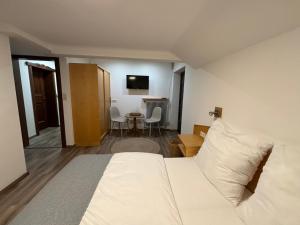 um quarto de hotel com uma cama e uma mesa em Pension Stöllinger mit Traumausblick em Fuschl am See