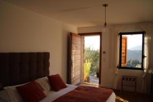 a bedroom with a bed and a large window at Casa Santa Lucia in Bocognano +103 photos