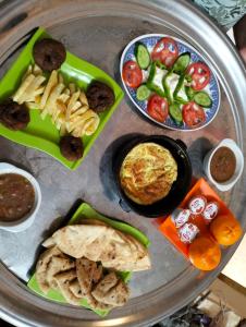 a plate of food with different types of food at Eka Dolli Elephanten in Aswan