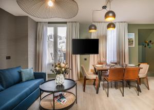 a living room with a blue couch and a table at Appart'hôtel East Paris Suite in Paris