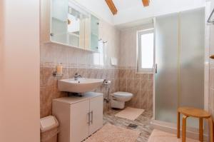 a bathroom with a sink and a toilet at Villa EVITA with sea view in Nerezine