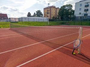 a tennis net on a tennis court with a tennis ball at Przystań - Aktywna strona Iłży in Iłża