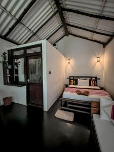 a bedroom with a bed and a door in a room at Secret Mountain Paradise in Ella