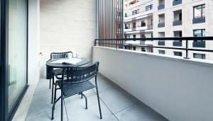 a balcony with two chairs and a table on a building at Italianway - Cecchi 18 B in Milan