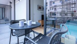 a table and chairs on the balcony of a building at Italianway - Cecchi 18 B in Milan