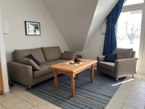 a living room with two couches and a coffee table at Das Landhaus am Haff B10 in Stolpe