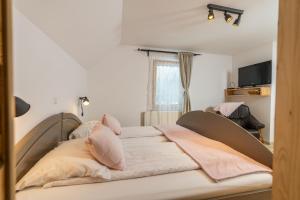 a large bed in a room with a window at Hiša Erlah in Bohinj
