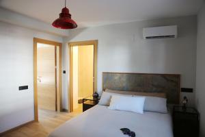 a bedroom with a white bed and a red light at La Boheme Casa Rural in Murchas +75 photos