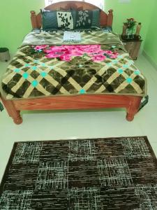 a bedroom with a bed and a rug at Michelle Residency in Rourkela