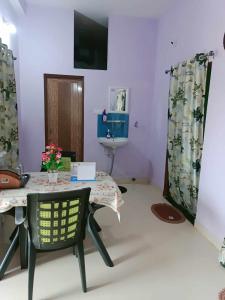a living room with a table and a sink at Michelle Residency in Rourkela